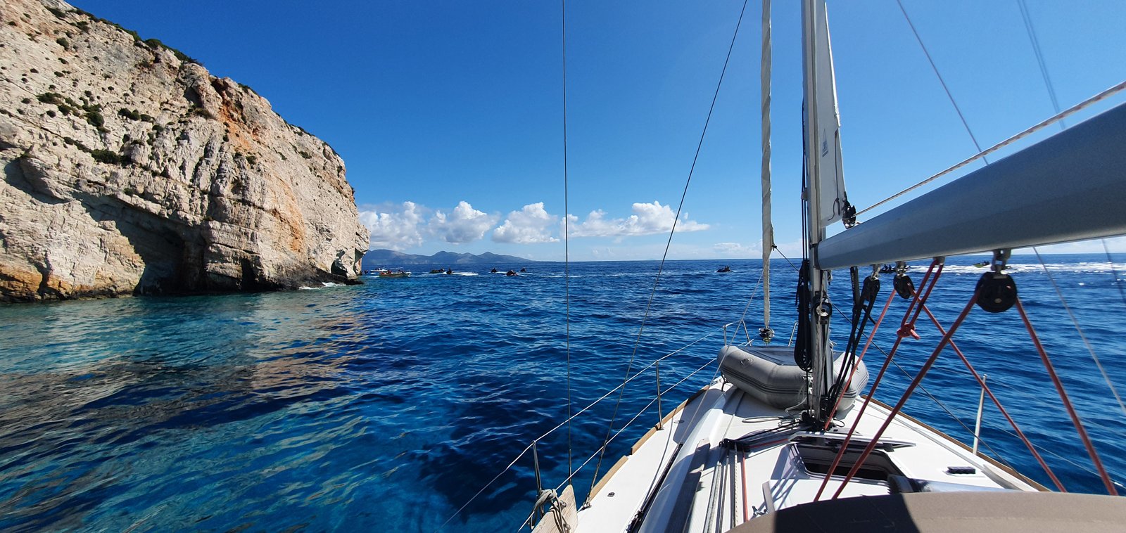 Bright blue water and steep cliffs on our anchorage in Greece